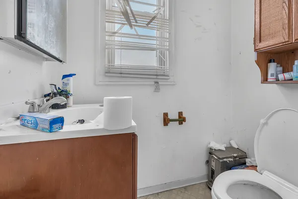 a bathroom with a sink toilet and a mirror