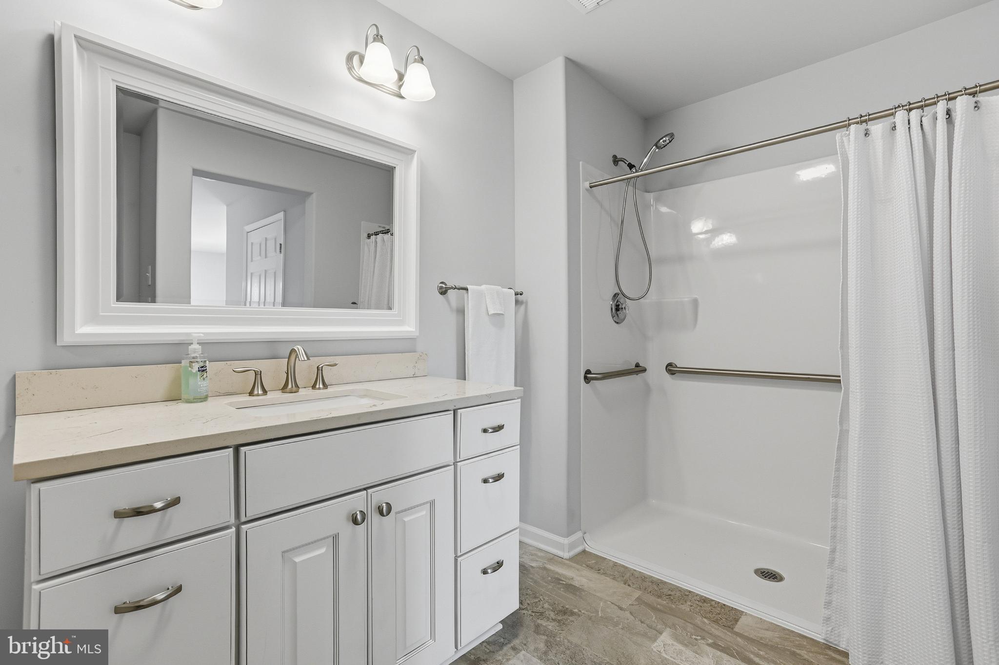 5810 West Hoover Road Reva, VA 22735 - Photo 14 of 25 a bathroom with a shower sink and mirror