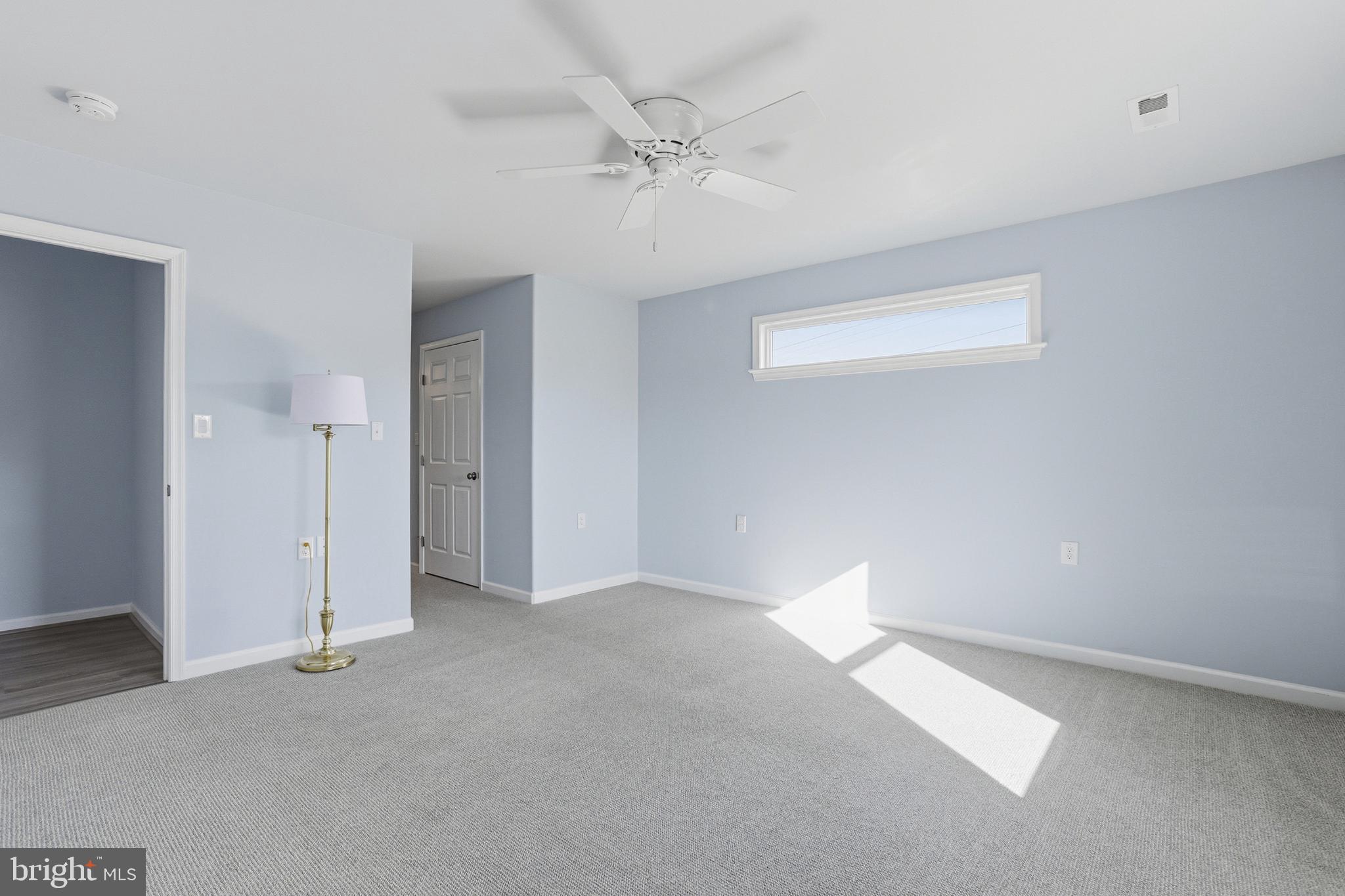 5810 West Hoover Road Reva, VA 22735 - Photo 15 of 25 an empty room with a ceiling fan and a window
