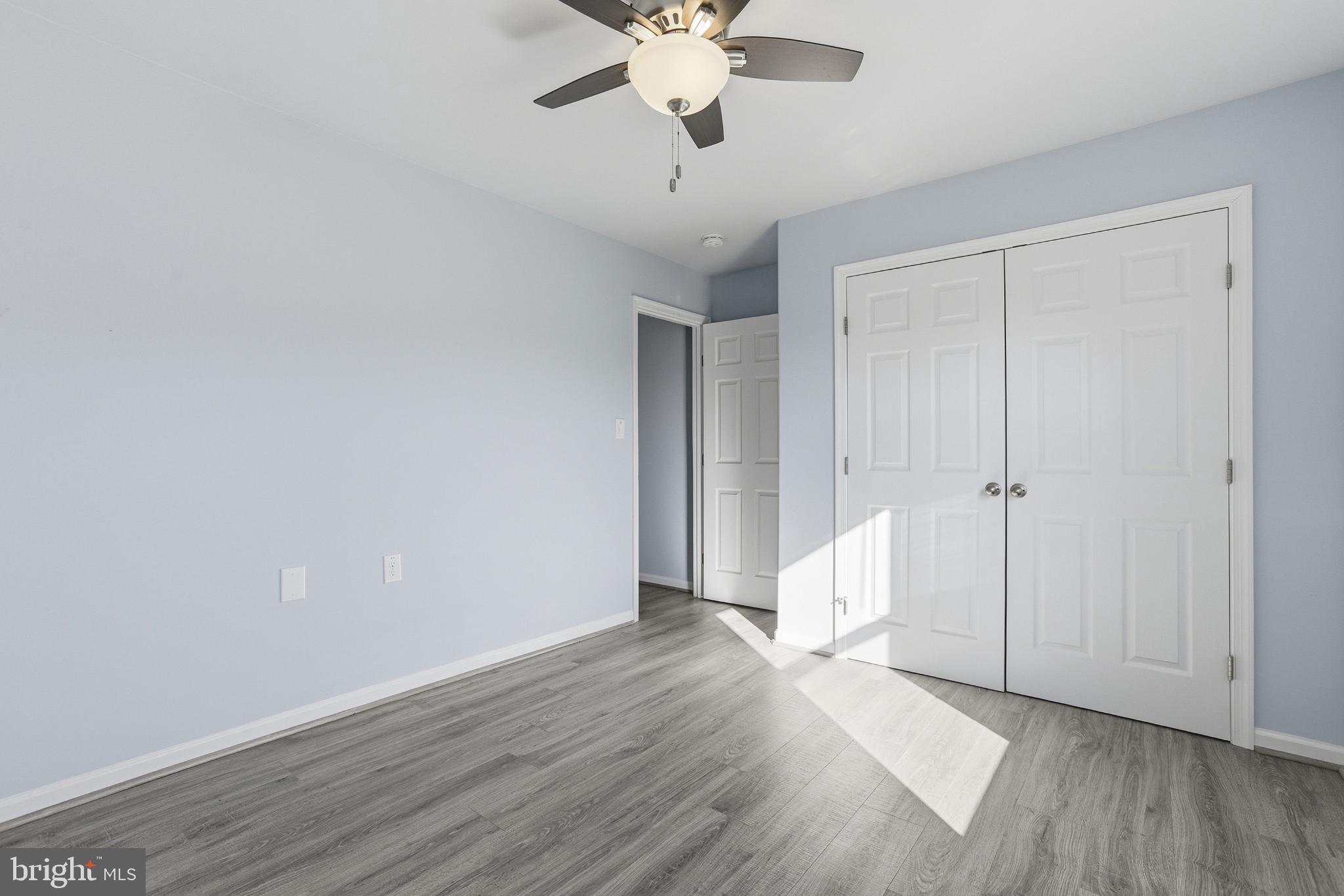 5810 West Hoover Road Reva, VA 22735 - Photo 20 of 25 a view of an empty room with wooden floor and a ceiling fan