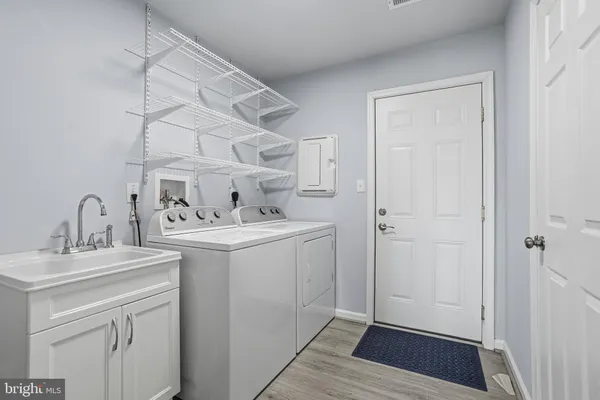 a utility room with cabinets washer and dryer