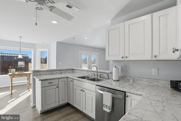 a kitchen with a sink window and cabinets