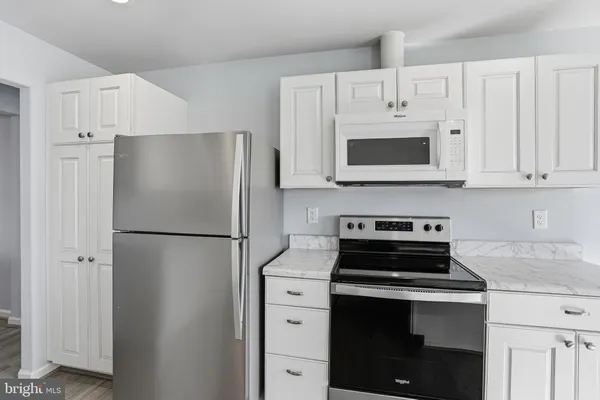 a white refrigerator freezer and a stove top oven