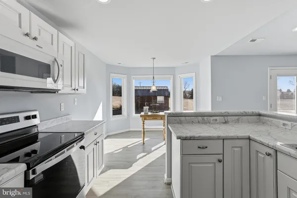 a kitchen with stainless steel appliances granite countertop a stove and a sink