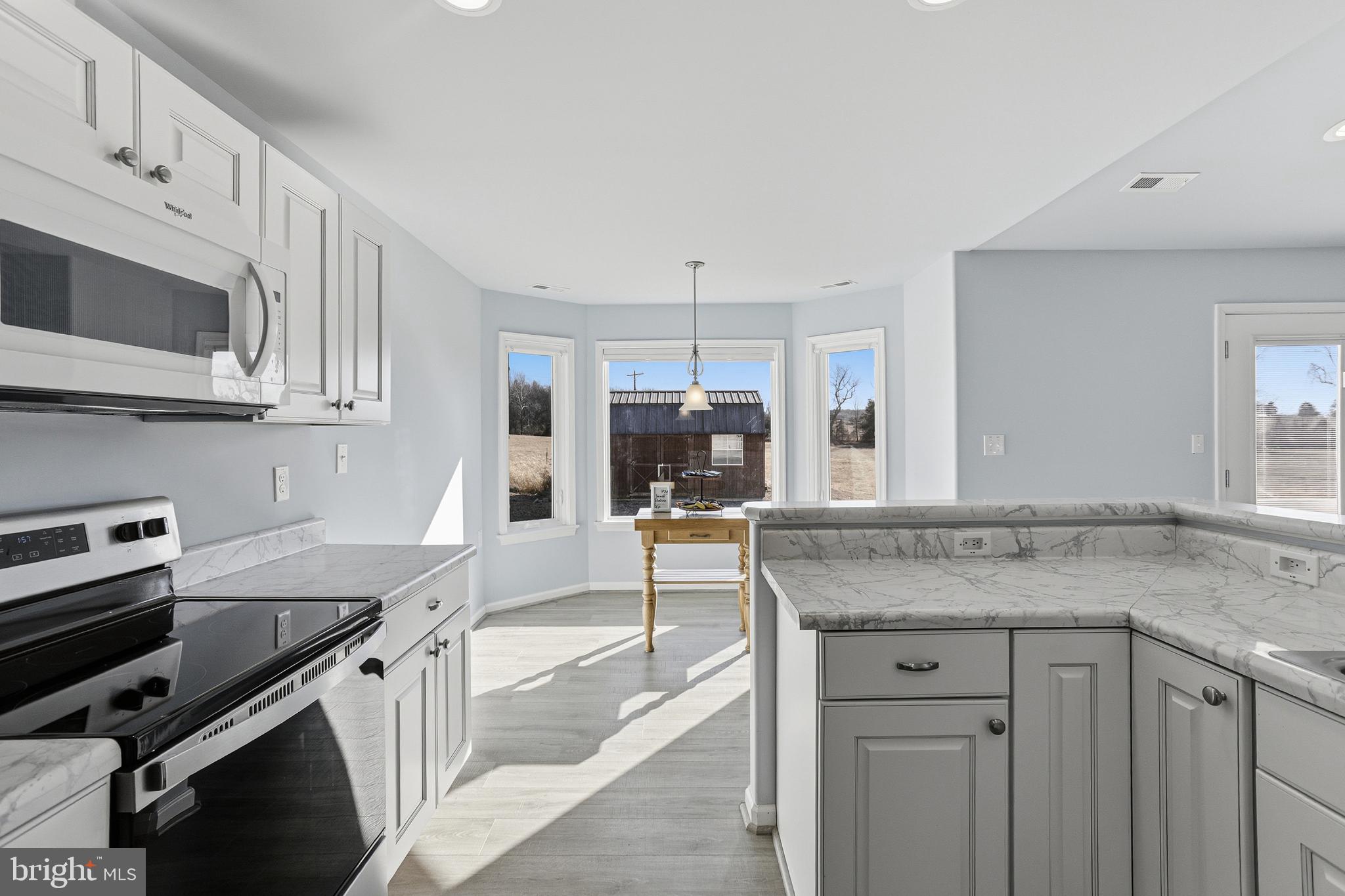 5810 West Hoover Road Reva, VA 22735 - Photo 10 of 25 a kitchen with stainless steel appliances granite countertop a stove and a sink