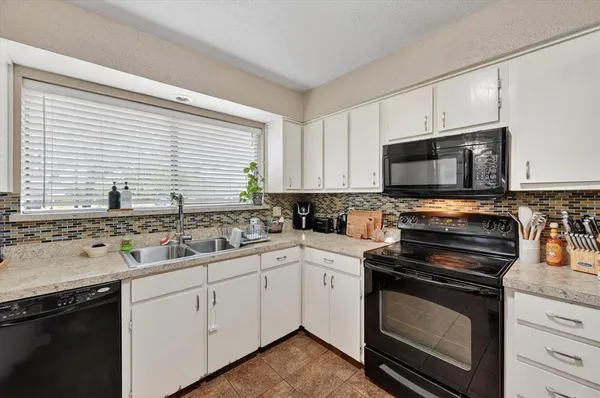 a kitchen with a sink stove and microwave