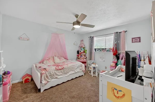 a bedroom with bed and a chandelier