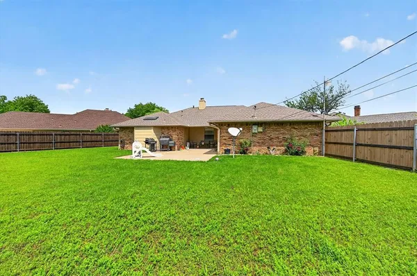 a front view of house with yard and outdoor seating