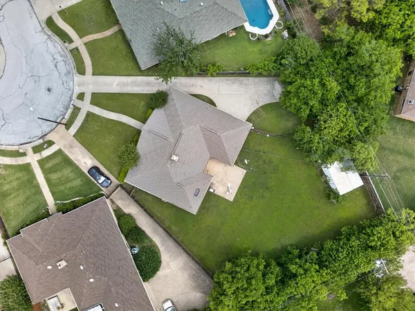 an aerial view of a house with garden space and street view