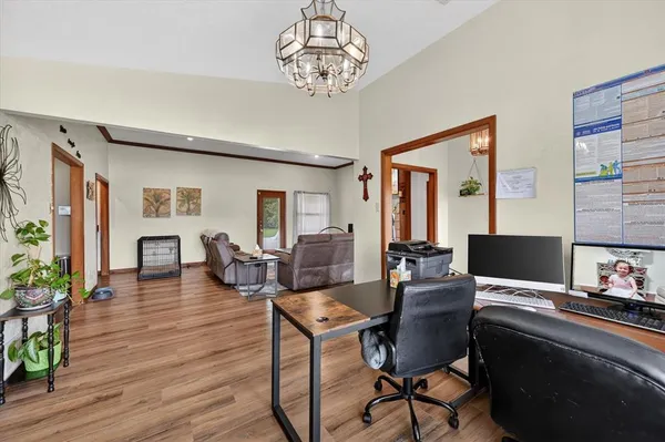 a view of a livingroom with furniture and a workspace