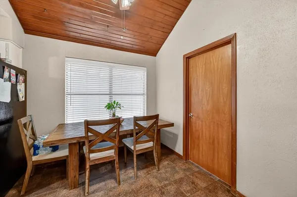 a view of a dining room with furniture and window