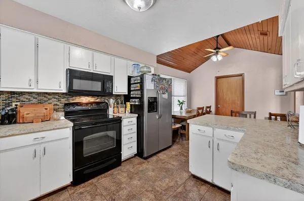 a kitchen with stainless steel appliances white cabinets and a sink