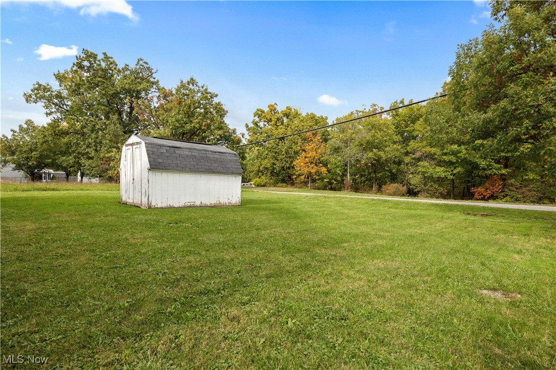 4341 Laurel Road Lorain, OH 44055 - Photo 27 of 36 View of yard featuring a storage shed