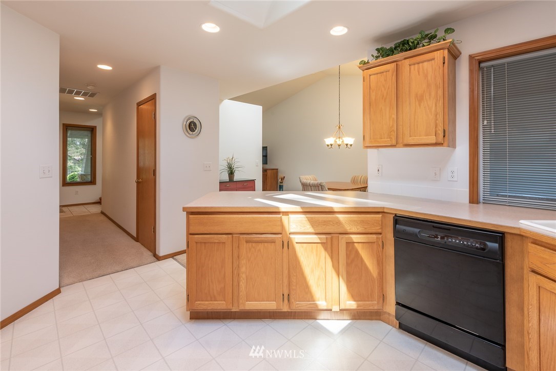 5203 53rd Street West University Place, WA 98467 - Photo 11 of 35 a kitchen with stainless steel appliances granite countertop a sink and a stove top oven