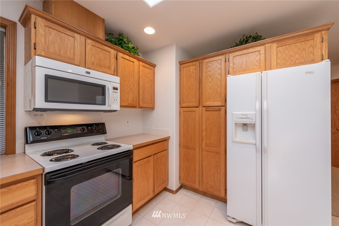 5203 53rd Street West University Place, WA 98467 - Photo 12 of 35 a kitchen with a refrigerator stove and microwave