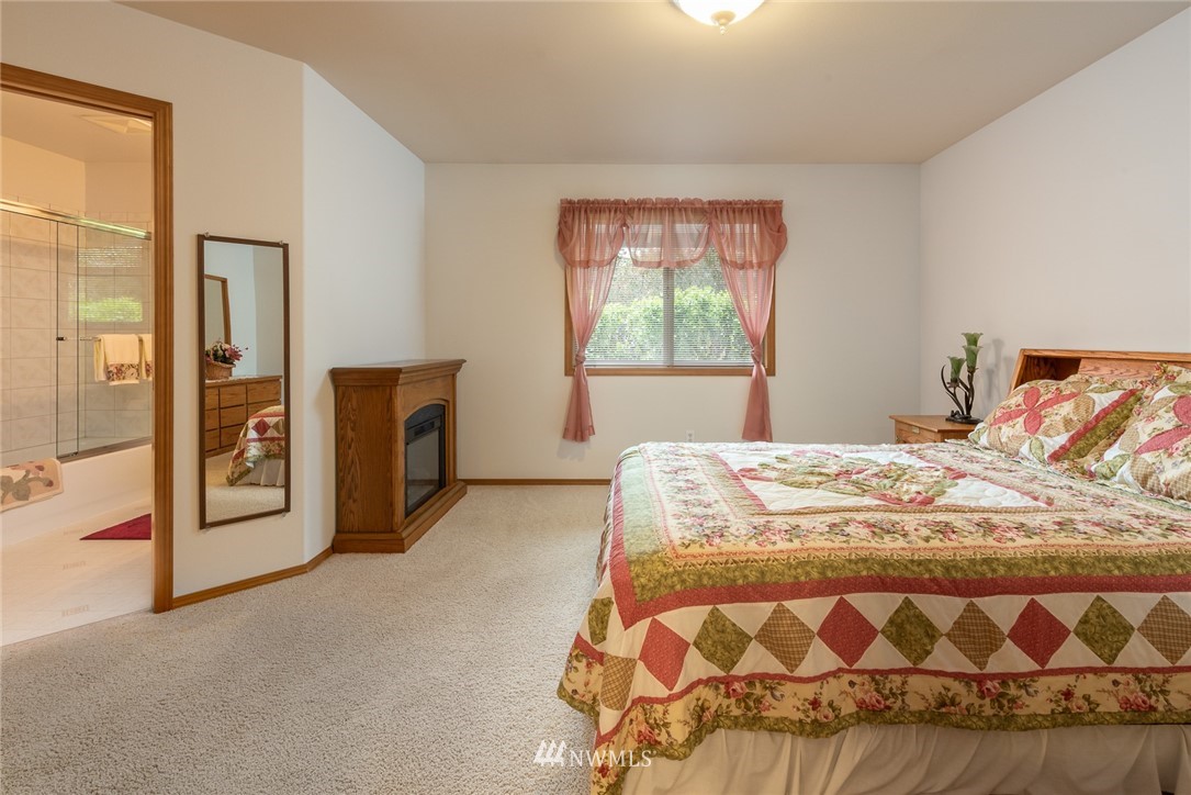 5203 53rd Street West University Place, WA 98467 - Photo 16 of 35 a bed sitting in a bedroom next to a window