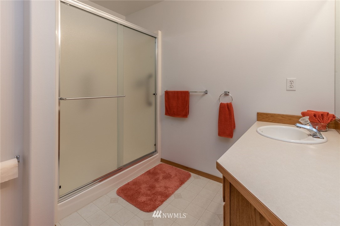 5203 53rd Street West University Place, WA 98467 - Photo 18 of 35 a bathroom with a sink and a shower curtain