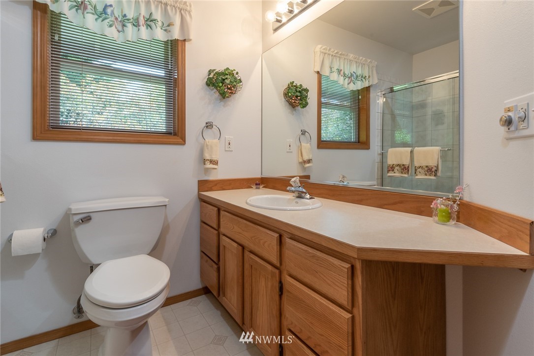 5203 53rd Street West University Place, WA 98467 - Photo 20 of 35 a bathroom with a sink toilet and a mirror