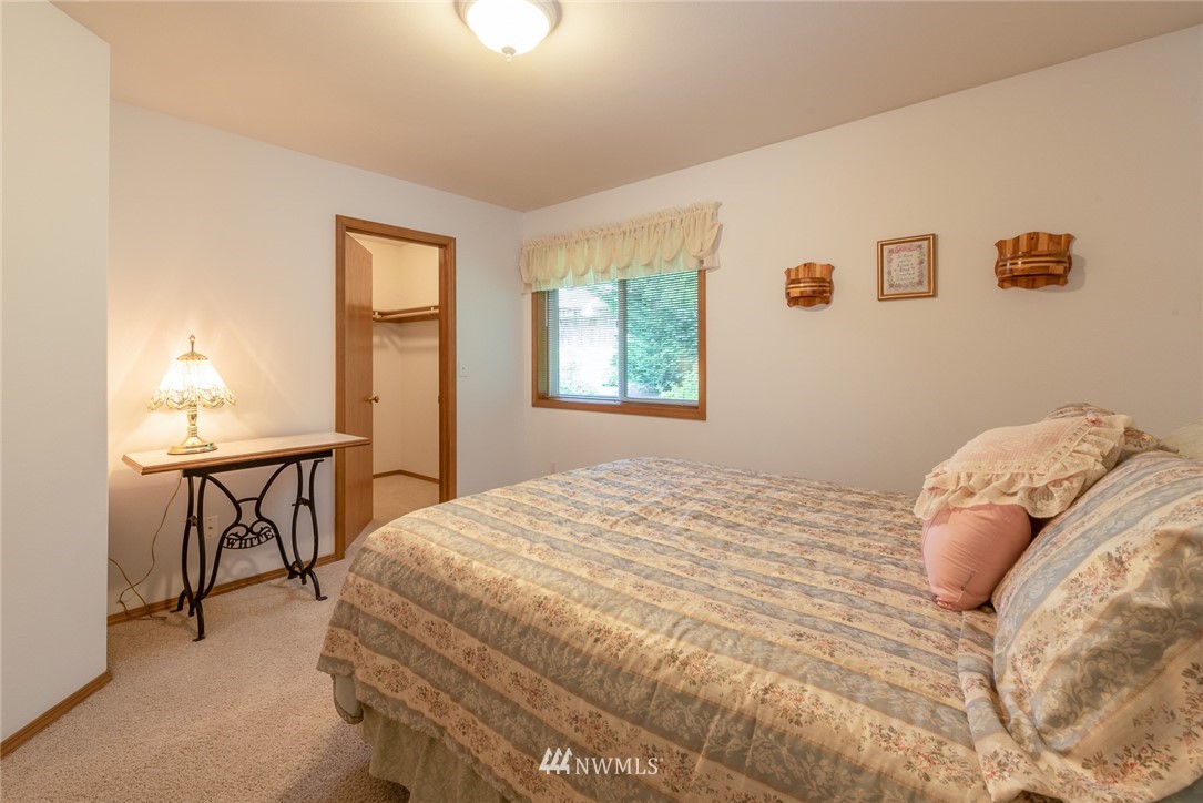 5203 53rd Street West University Place, WA 98467 - Photo 24 of 35 a bedroom with a bed table and chair