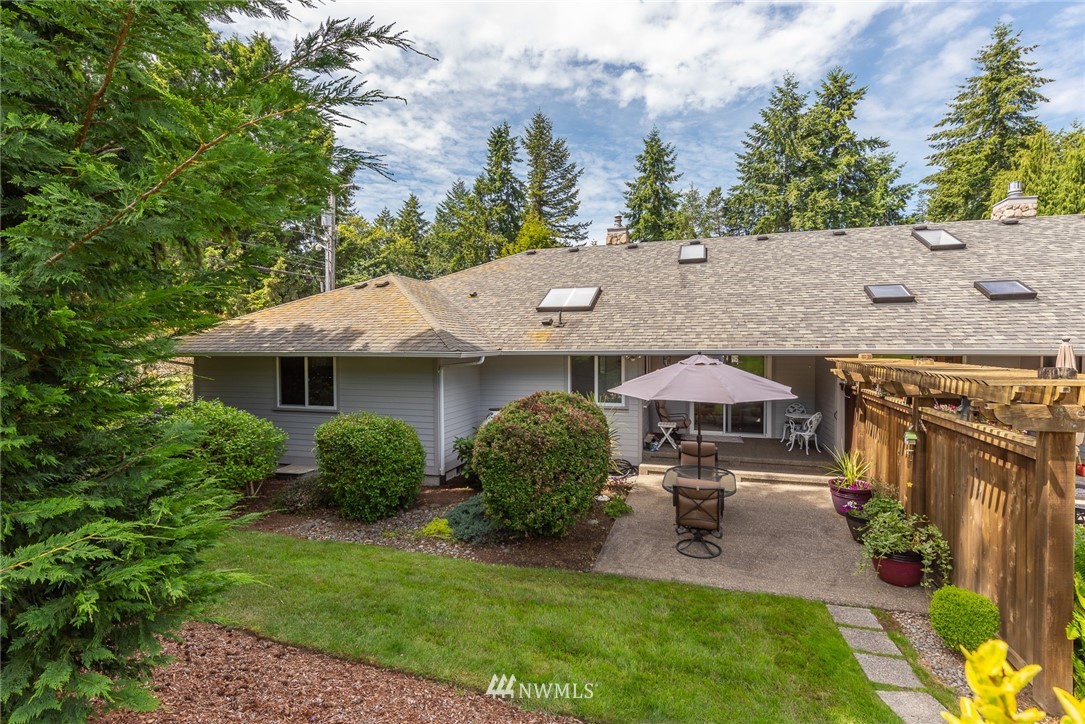 5203 53rd Street West University Place, WA 98467 - Photo 33 of 35 an aerial view of a house with garden space and trees