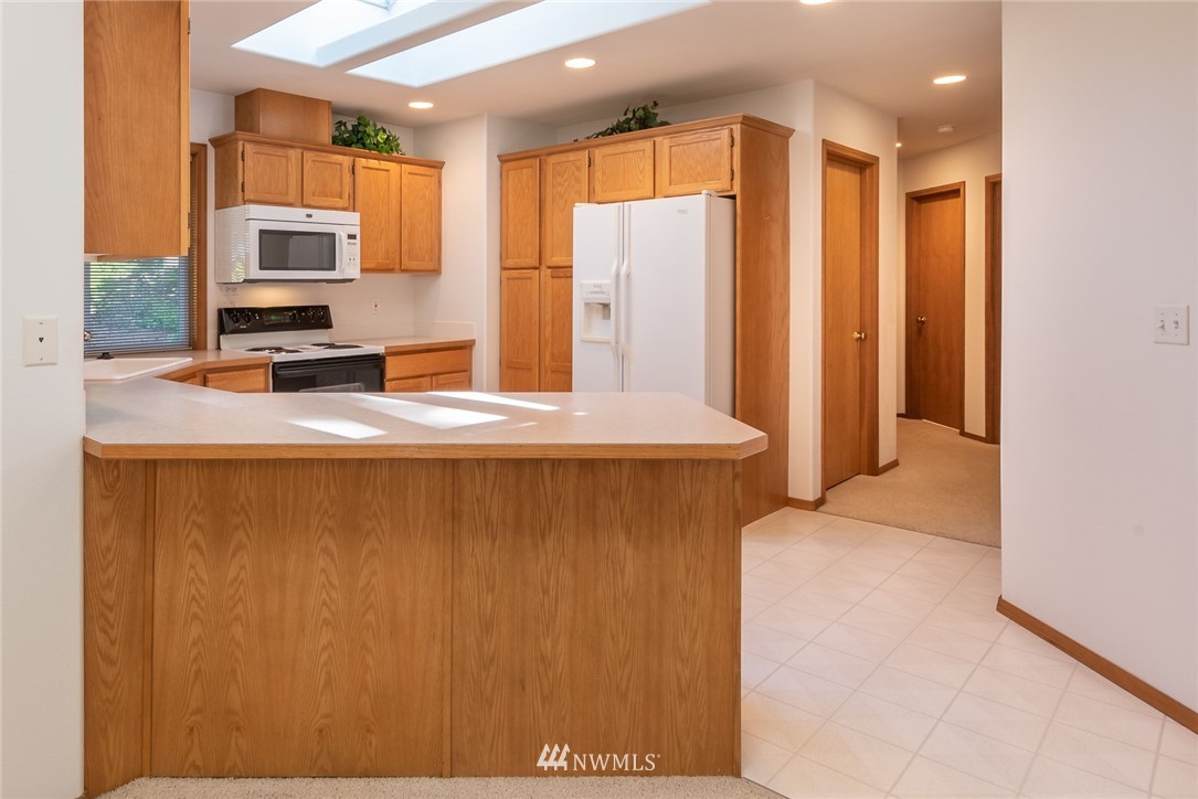 5203 53rd Street West University Place, WA 98467 - Photo 8 of 35 a view of kitchen with stainless steel appliances granite countertop a refrigerator a stove top oven a sink and dishwasher