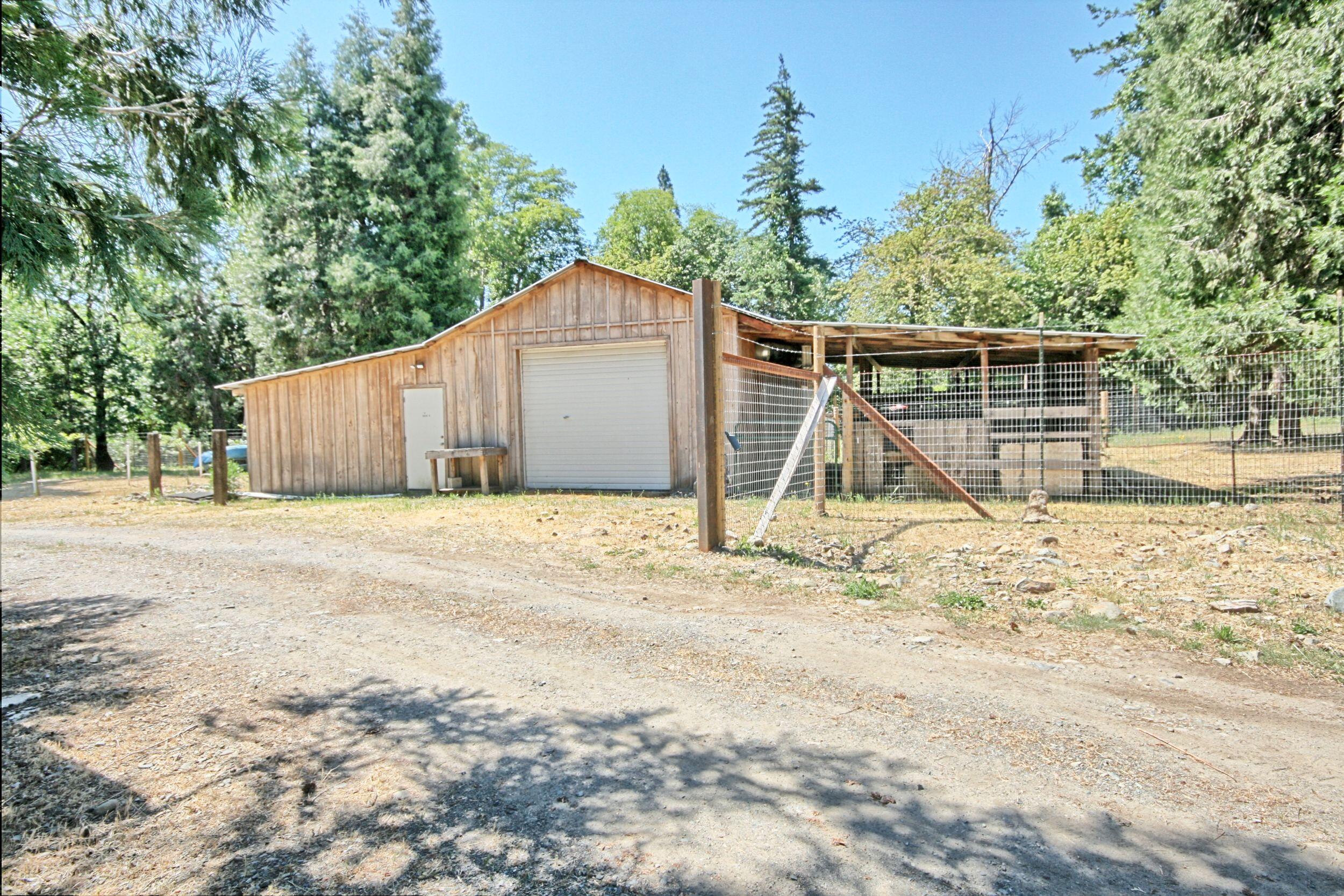 199 Powell Creek Road Williams, OR 97544 - Photo 46 of 57 a view of a yard with wooden fence and trees