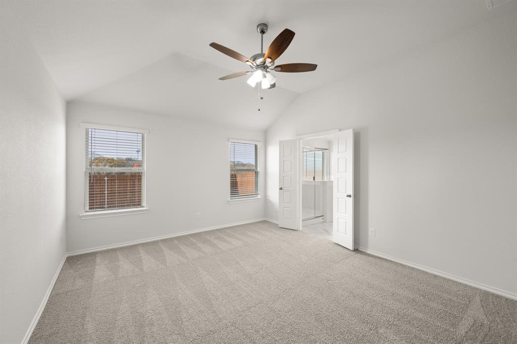 1184 Oak Spring Drive Burleson, TX 76028 - Photo 18 of 27 a view of an empty room with a ceiling fan