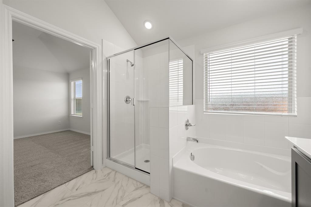 1184 Oak Spring Drive Burleson, TX 76028 - Photo 22 of 27 a bathroom with a bathtub and a shower