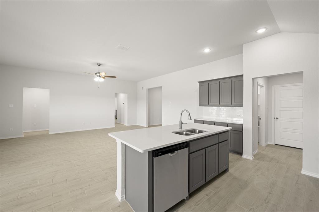 1184 Oak Spring Drive Burleson, TX 76028 - Photo 8 of 27 a kitchen with a sink a counter space and appliances