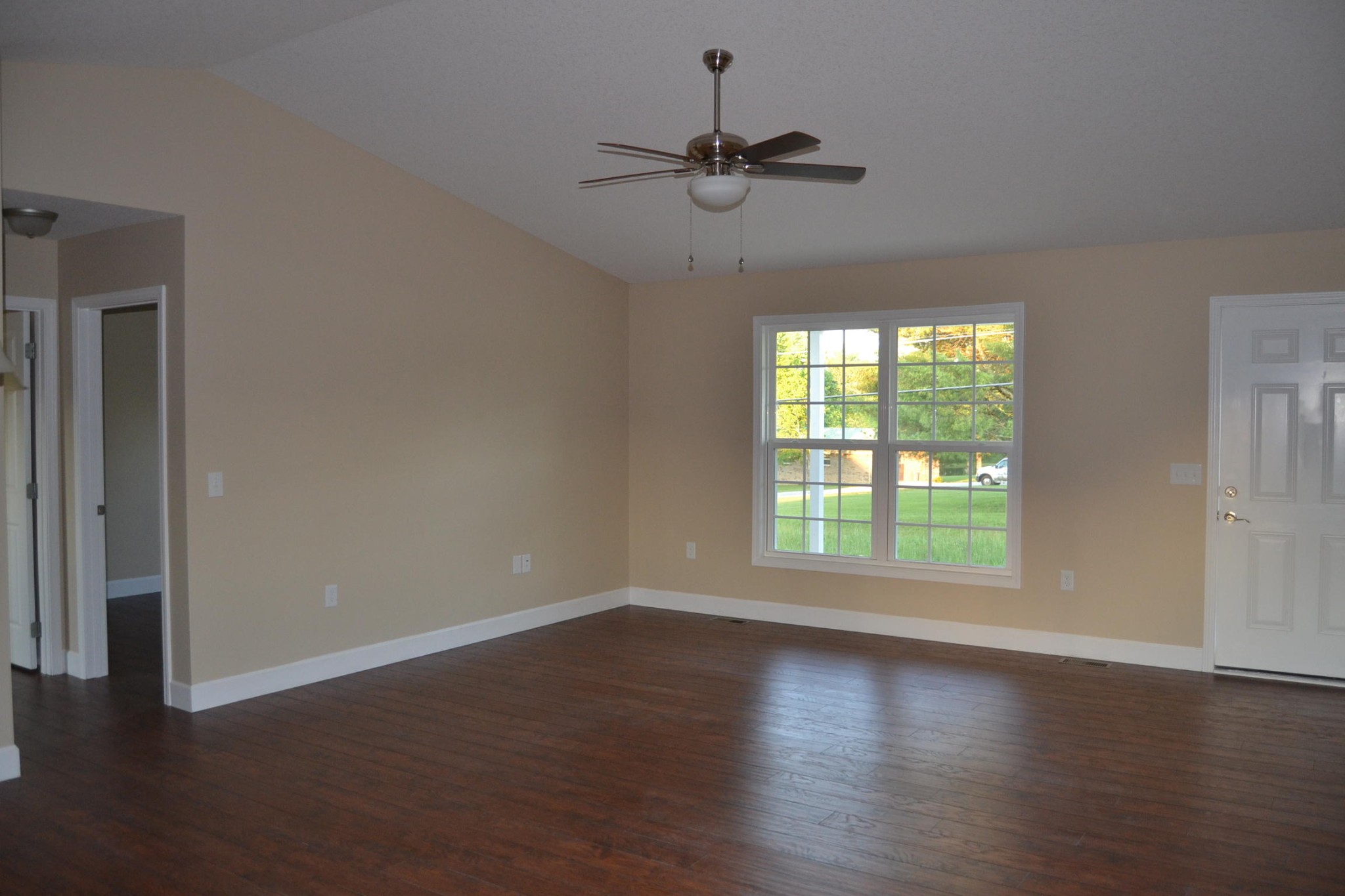 41 York Road Crossville, TN 38555 - Photo 4 of 17 an empty room with wooden floor fan and windows