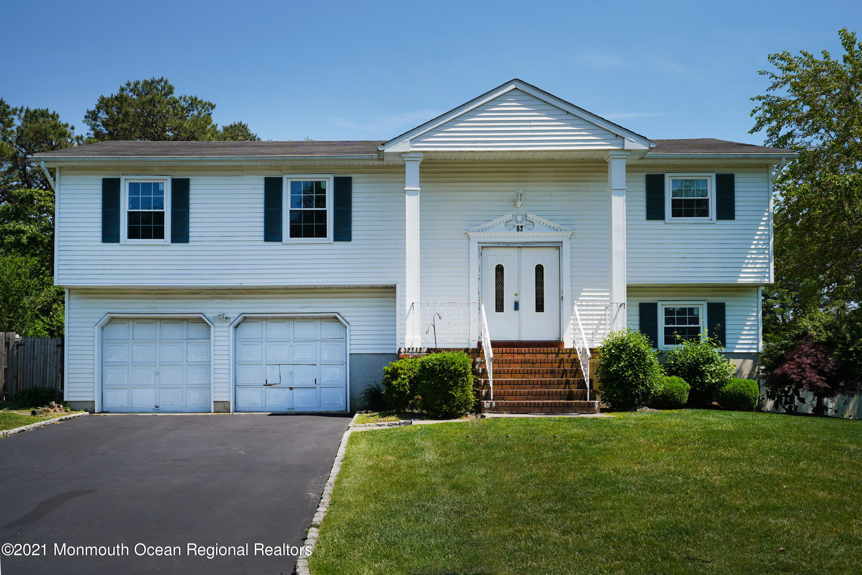 52 Danbury Road Tinton Falls, NJ 07753 - Photo 1 of 50 a front view of a house with a yard and garage