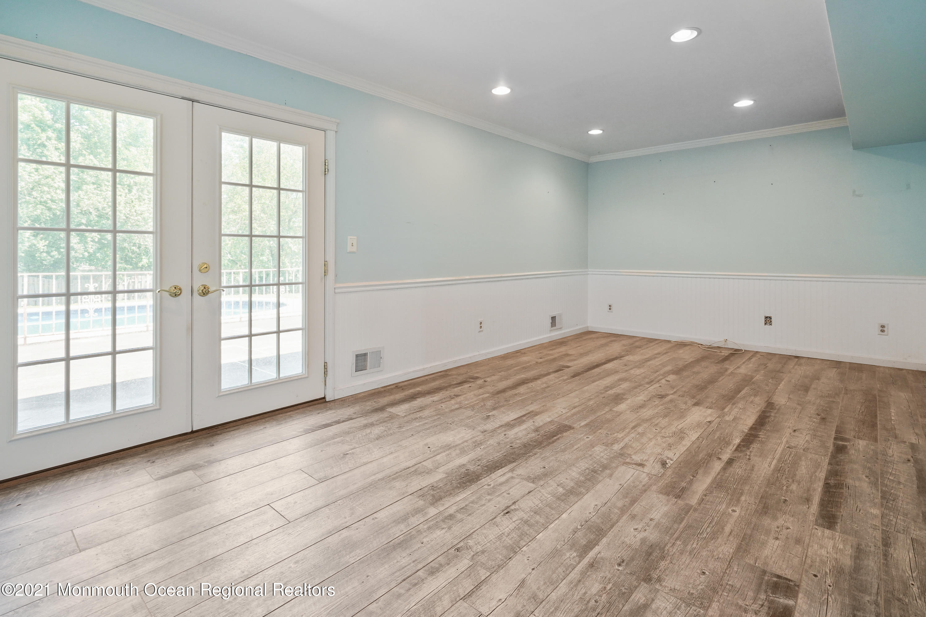 52 Danbury Road Tinton Falls, NJ 07753 - Photo 14 of 50 an empty room with wooden floor and windows