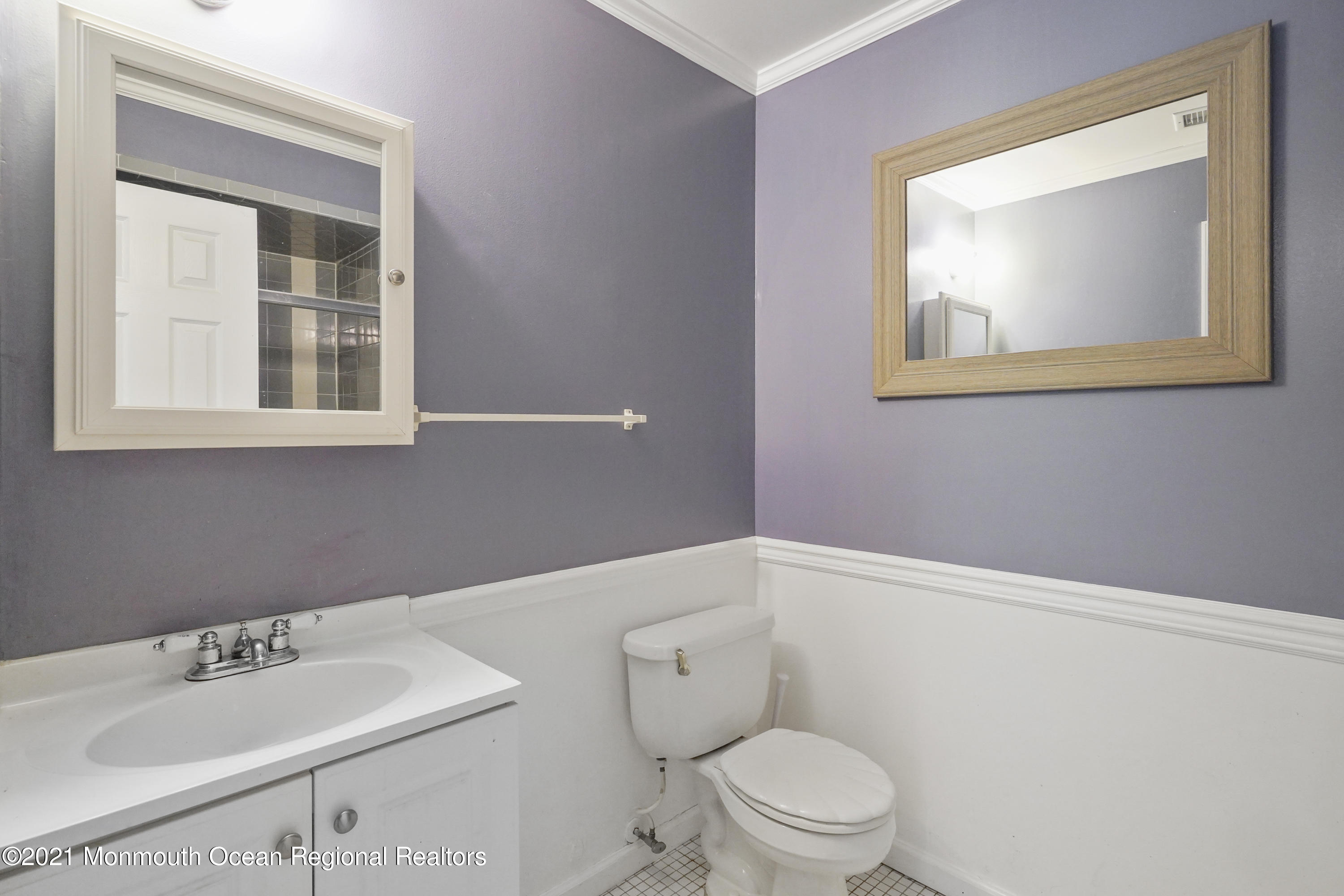 52 Danbury Road Tinton Falls, NJ 07753 - Photo 20 of 50 a bathroom with a toilet sink and mirror