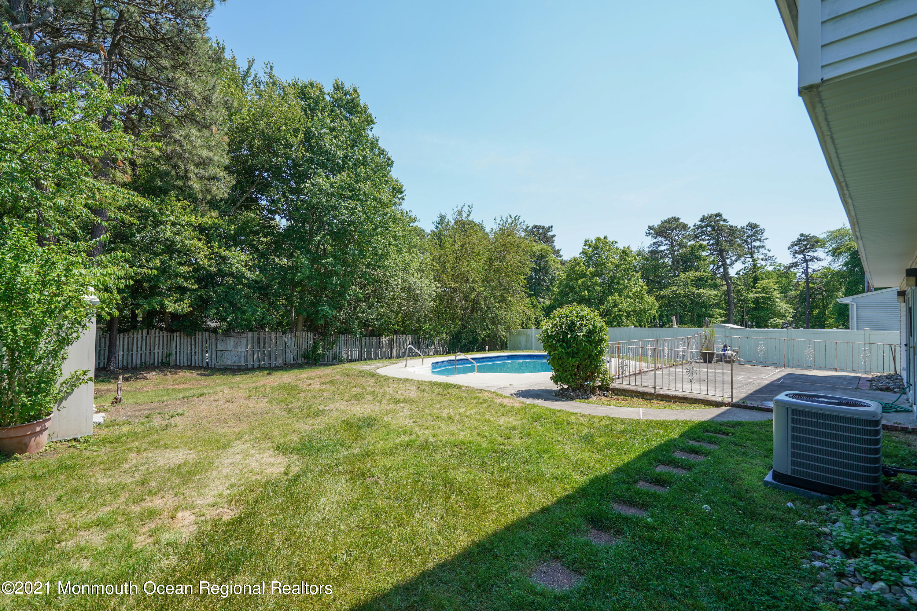 52 Danbury Road Tinton Falls, NJ 07753 - Photo 26 of 50 a view of a patio with a table and chairs a fire pit and grass