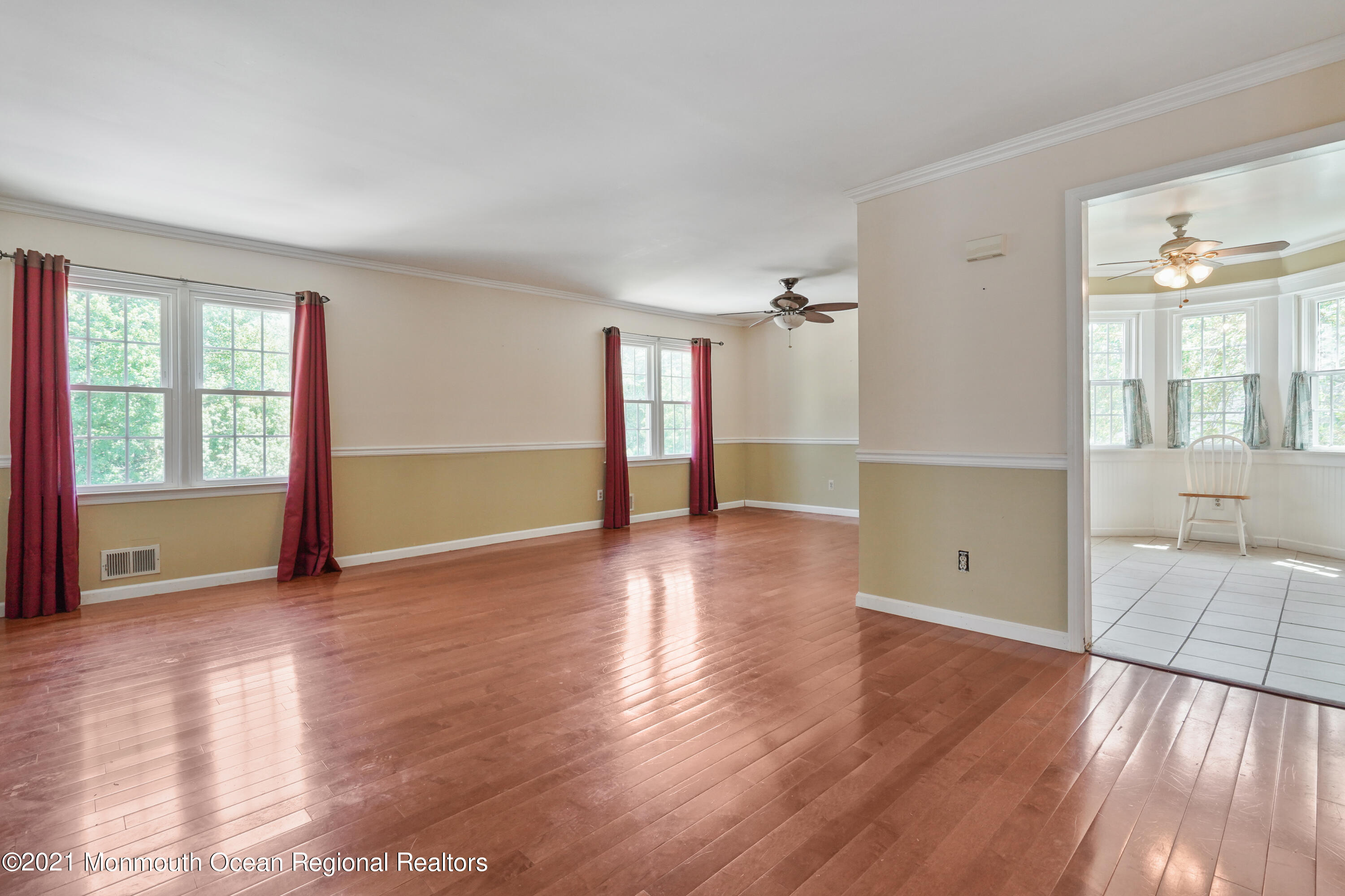 52 Danbury Road Tinton Falls, NJ 07753 - Photo 4 of 50 an empty room with wooden floor and windows