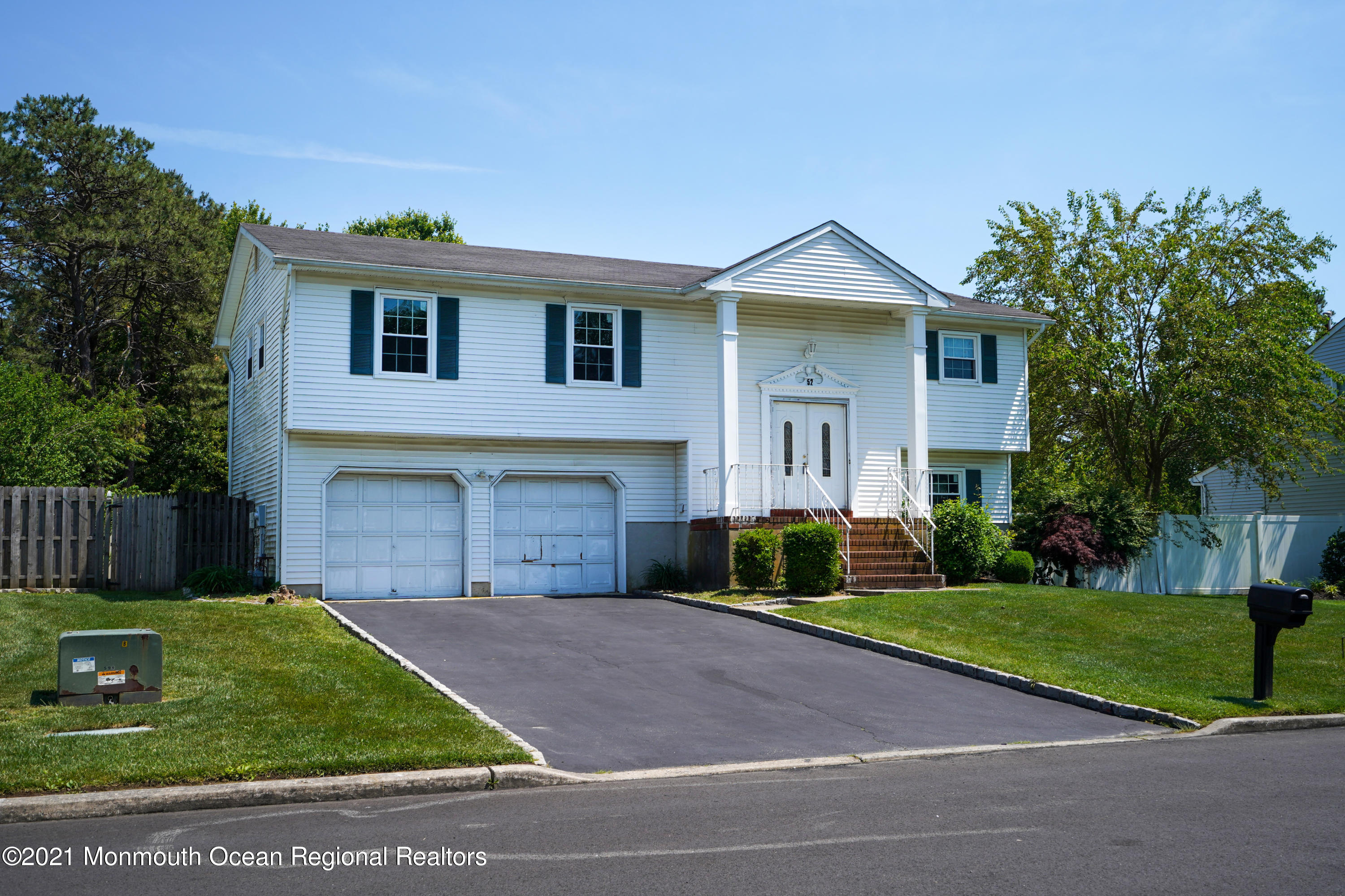 52 Danbury Road Tinton Falls, NJ 07753 - Photo 49 of 50 a front view of a house with a yard and garage