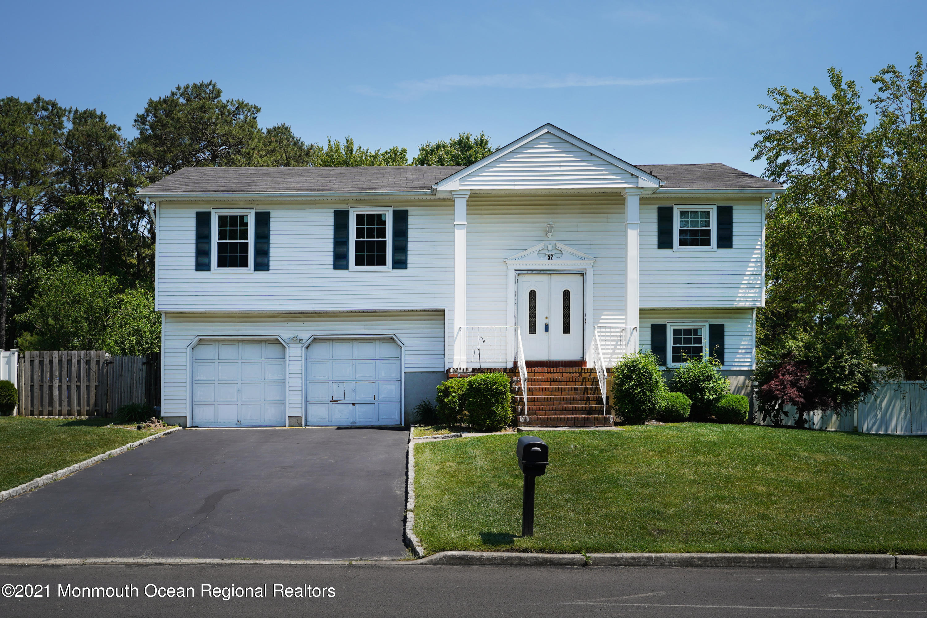 52 Danbury Road Tinton Falls, NJ 07753 - Photo 50 of 50 a front view of a house with a yard and garage
