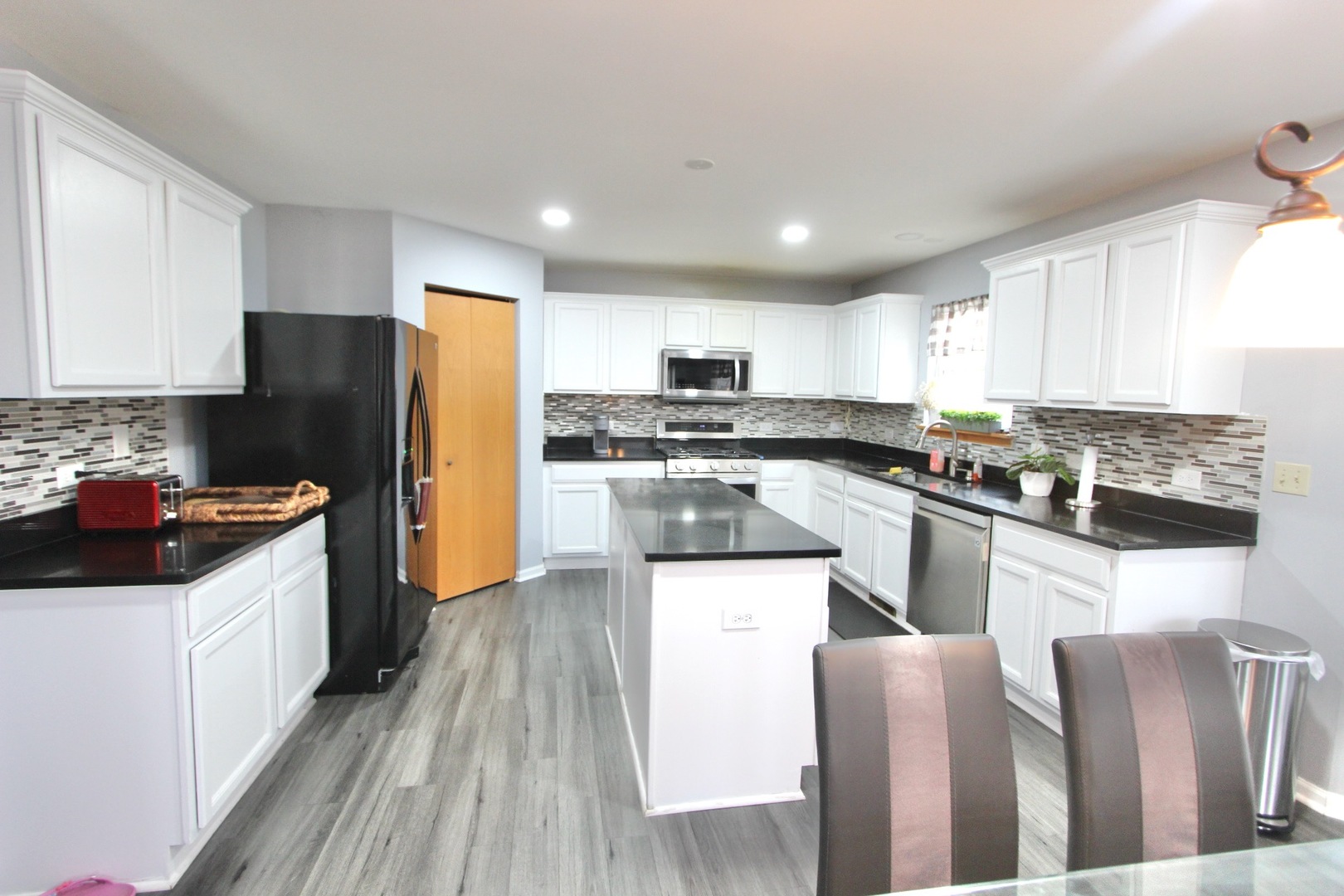 1458 Wildmeadow Road Round Lake, IL 60073 - Photo 13 of 45 a kitchen with stainless steel appliances granite countertop a refrigerator stove microwave and sink