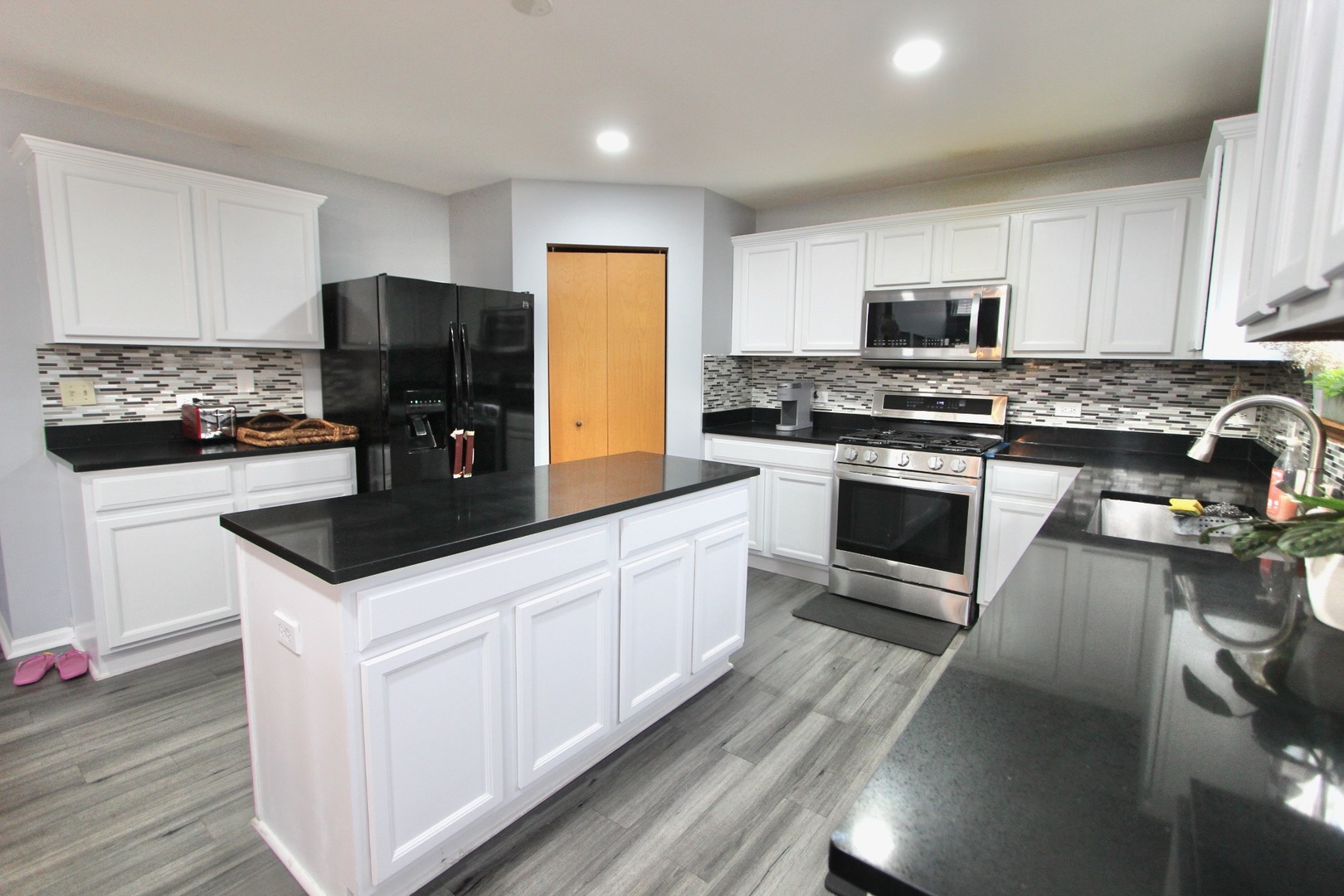 1458 Wildmeadow Road Round Lake, IL 60073 - Photo 14 of 45 a kitchen with stainless steel appliances a stove a sink and a microwave