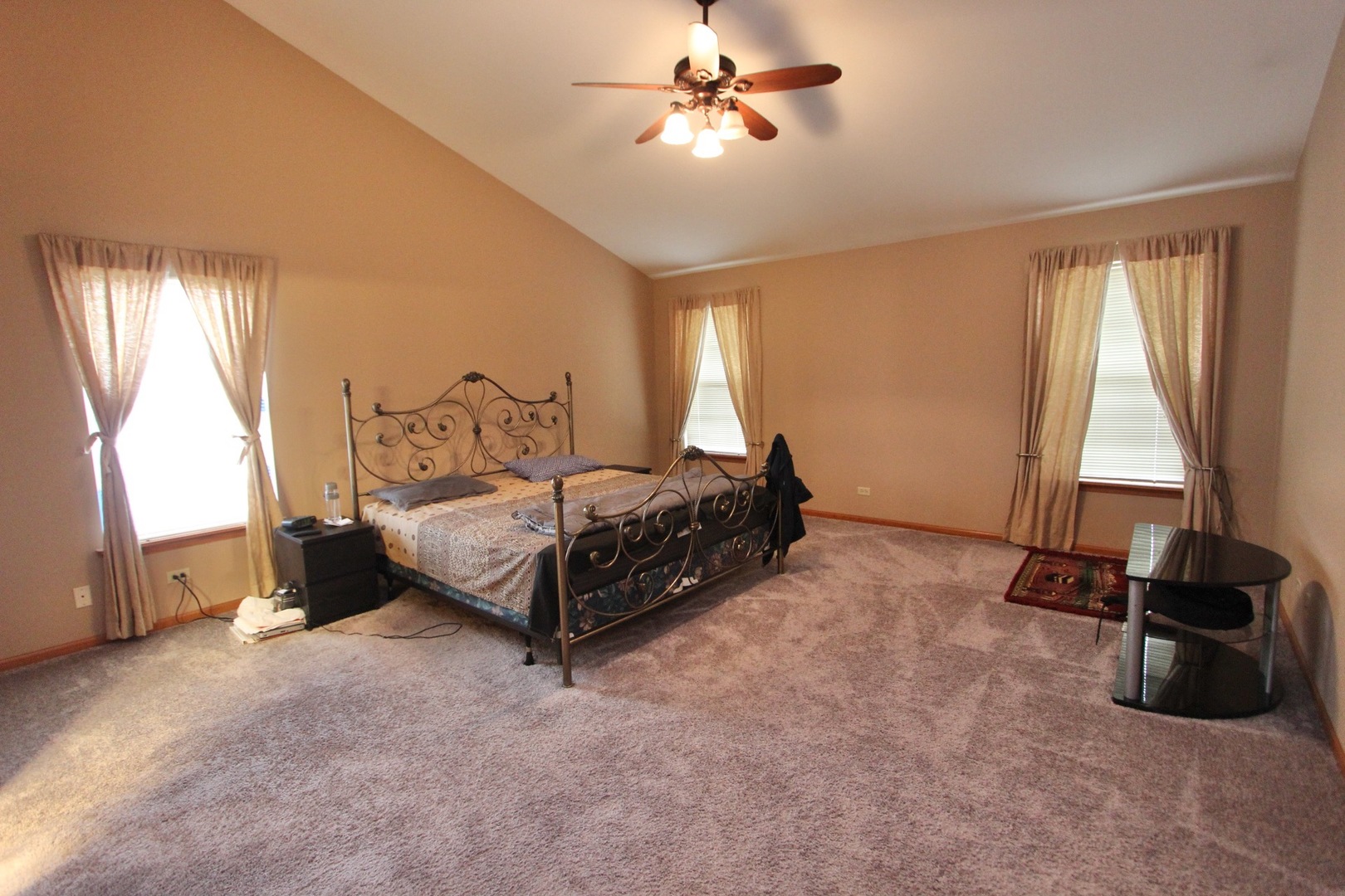 1458 Wildmeadow Road Round Lake, IL 60073 - Photo 25 of 45 a bedroom with a bed a dresser and a large window