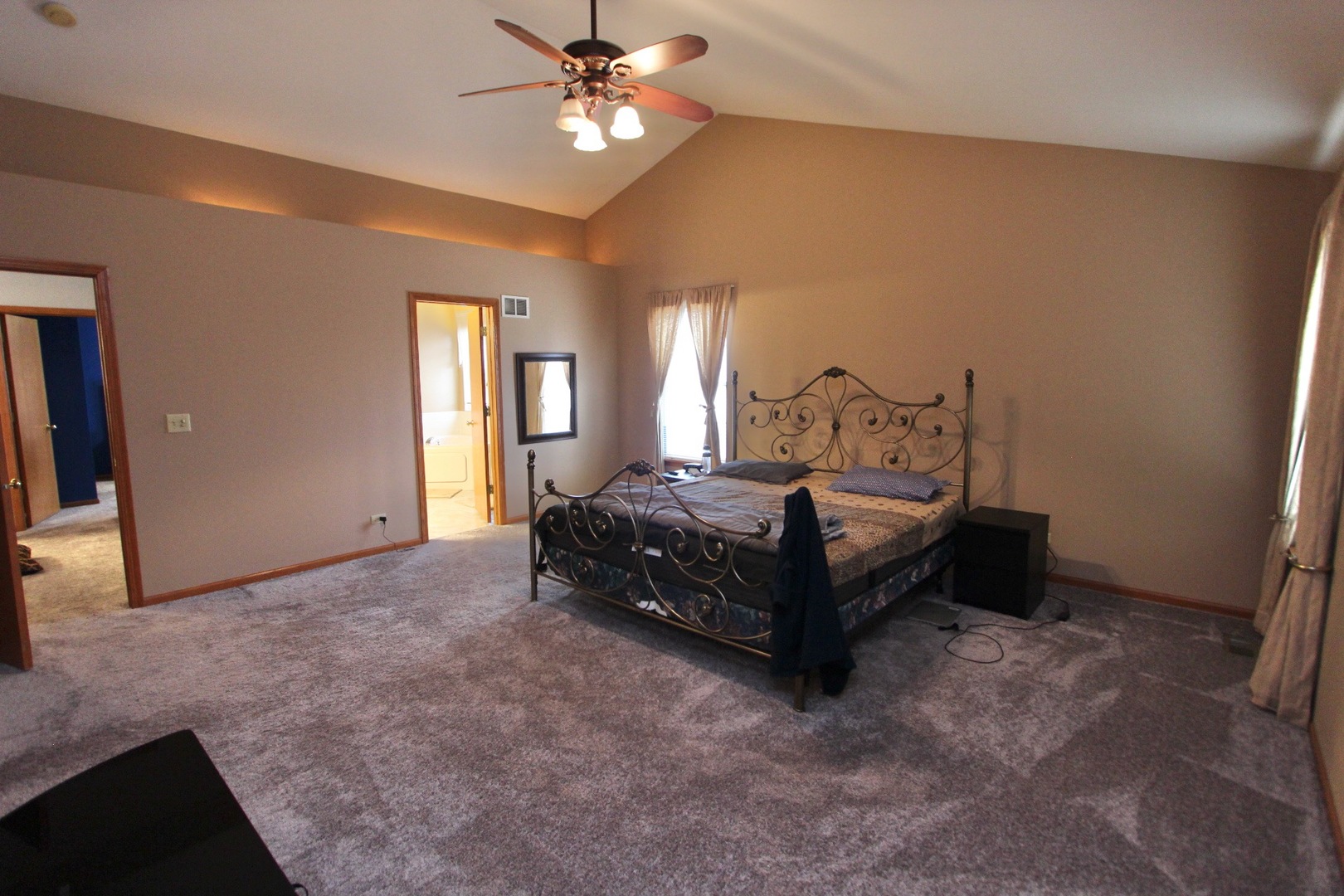 1458 Wildmeadow Road Round Lake, IL 60073 - Photo 26 of 45 a bedroom with a bed lamp and a chandelier