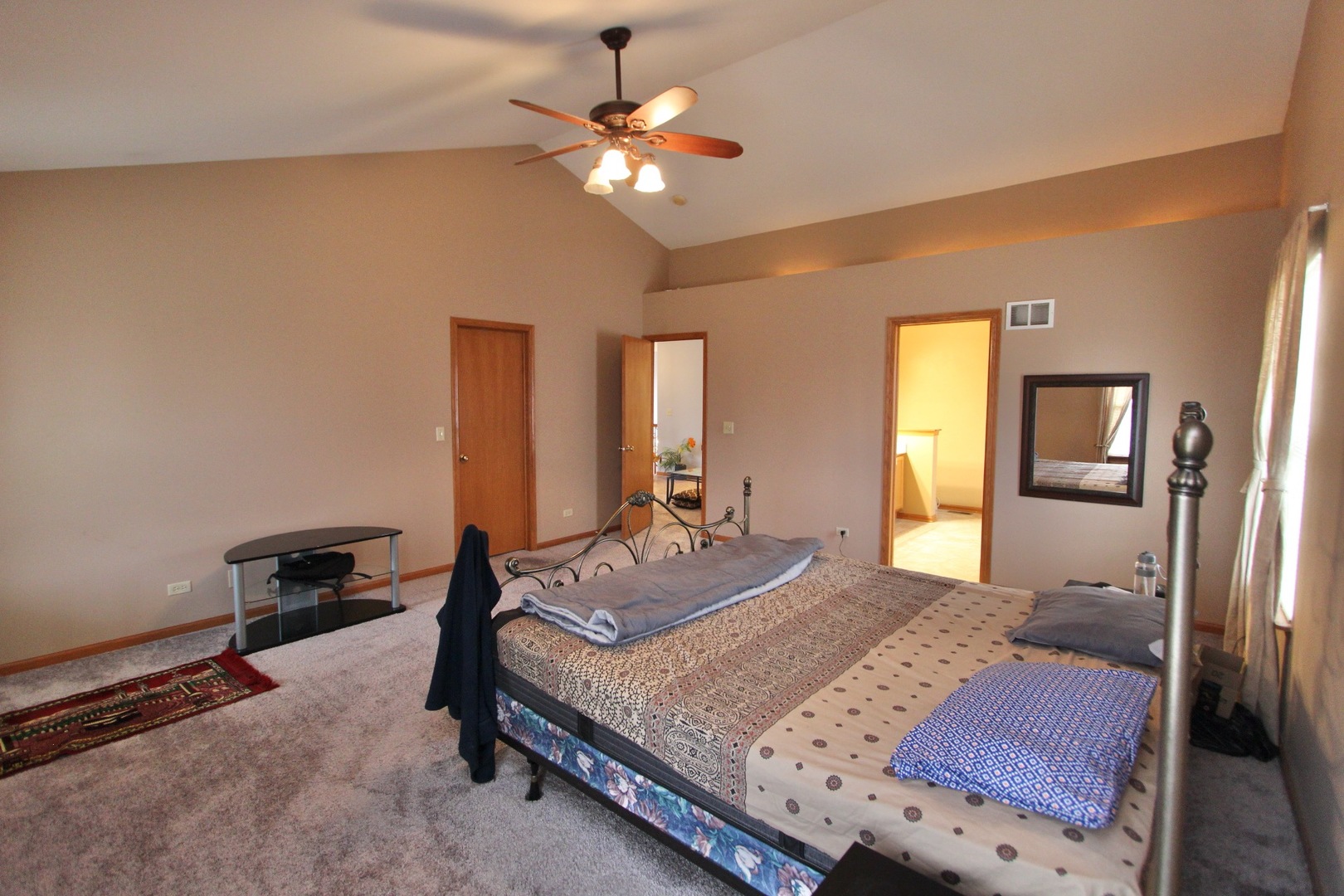 1458 Wildmeadow Road Round Lake, IL 60073 - Photo 27 of 45 a bedroom with a large bed and a chandelier
