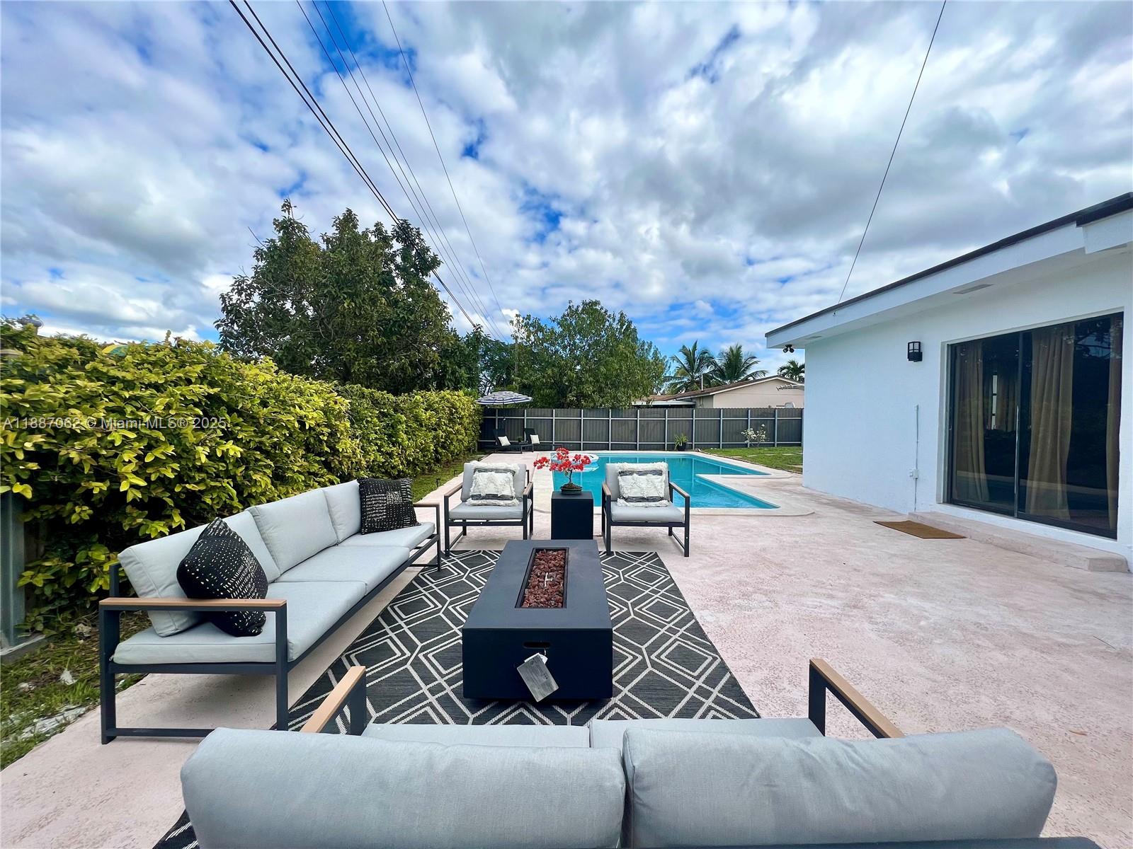 a roof deck with couches and potted plants