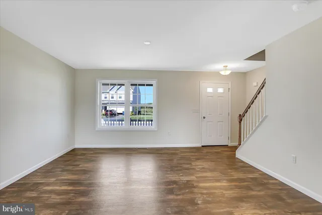 a view of an entryway with wooden floor