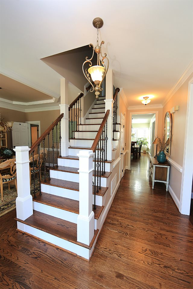 9101 Tealby Place Raleigh, NC 27615 - Photo 4 of 30 Foyer and open staircase with wrought iron pickets and hardwood floors. Foyer