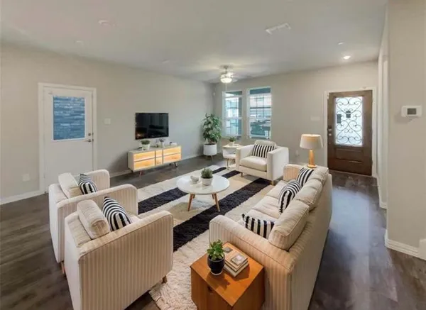 a living room with furniture and a flat screen tv