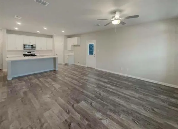 a view of kitchen with refrigerator and window
