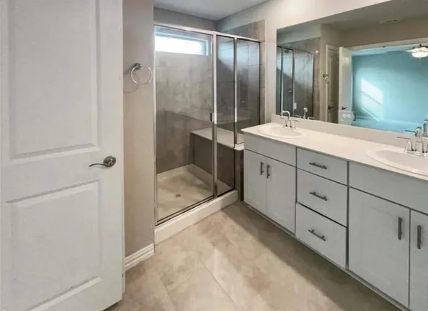 a bathroom with a double vanity sink toilet and shower