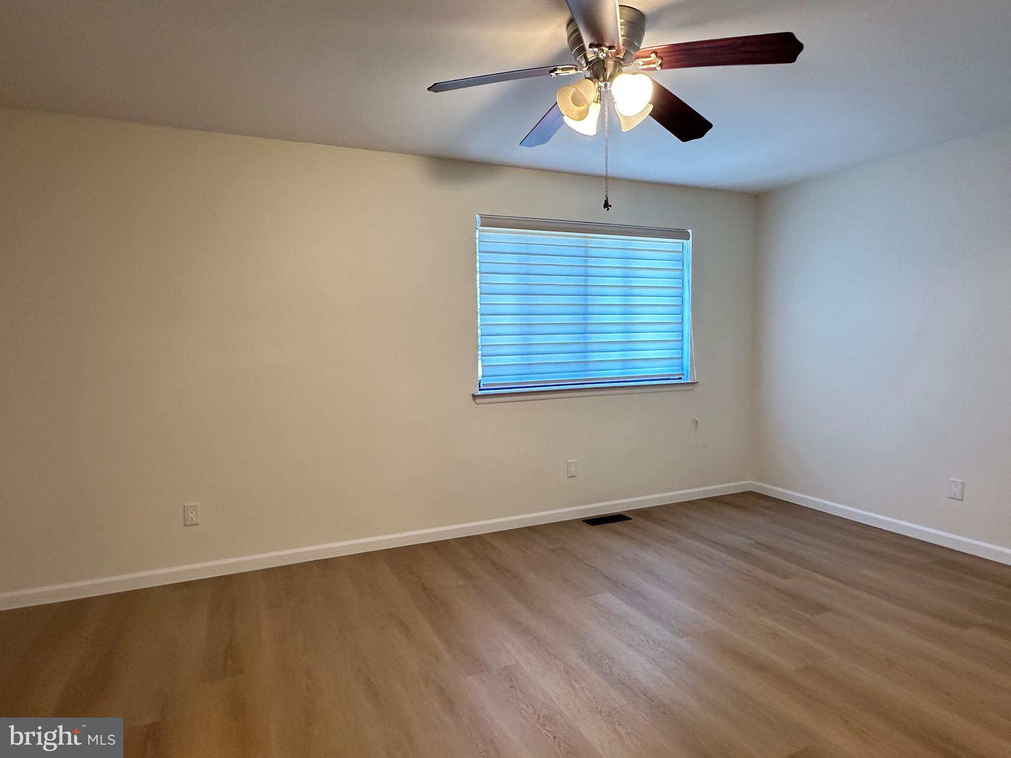 3 Centennial Road Telford, PA 18969 - Photo 20 of 25 an empty room with wooden floor chandelier fan and windows