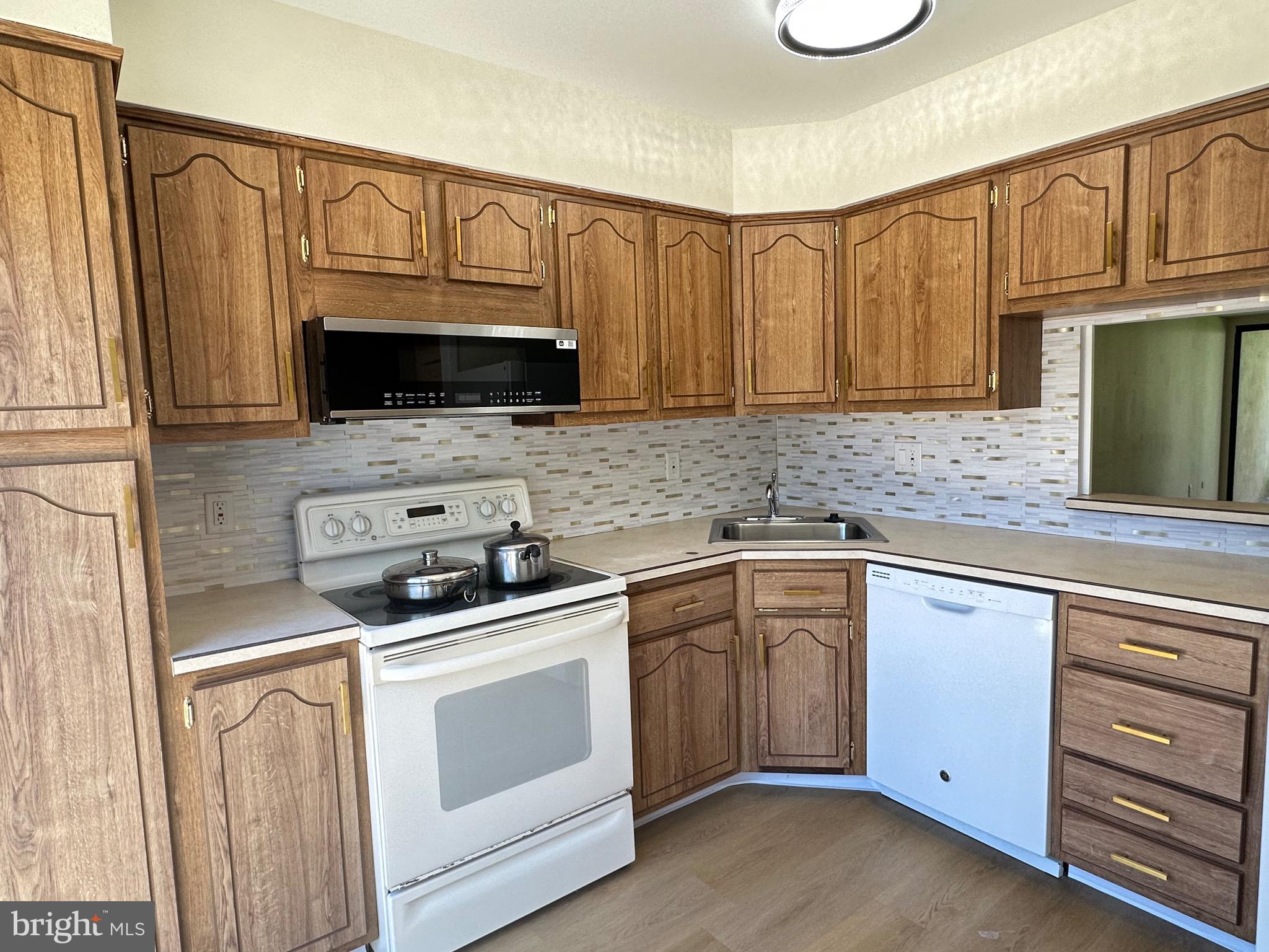 3 Centennial Road Telford, PA 18969 - Photo 3 of 25 a kitchen with stainless steel appliances granite countertop a sink a stove a microwave and cabinets
